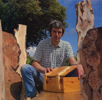 Peter Lloyd sitting with a box